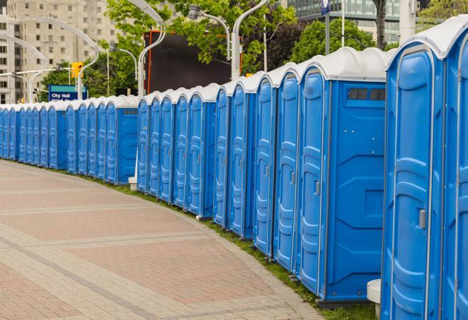 a row of portable restrooms set up for a large athletic event, allowing participants and spectators to easily take care of their needs in Fountain Valley